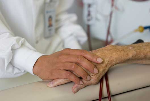 patient holding hands with support person